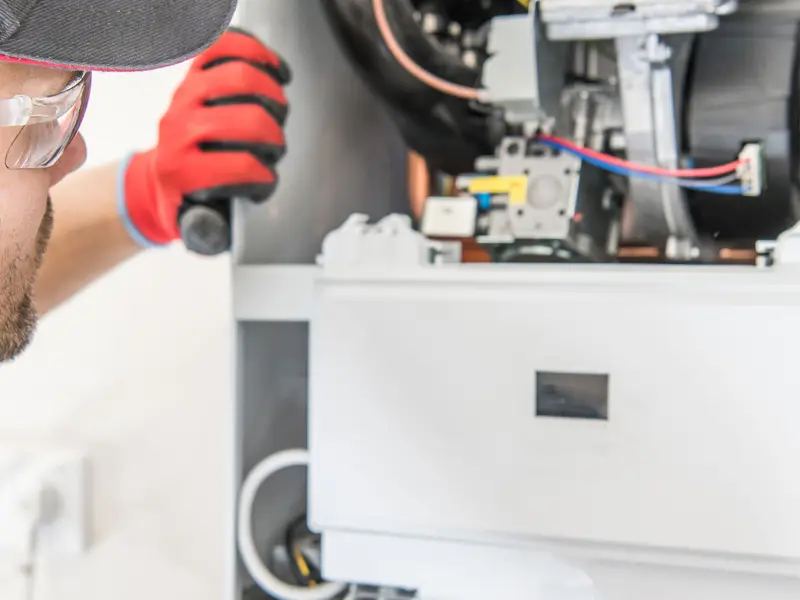 Gas engineer repairing a broken down boiler System Servicing Lincoln